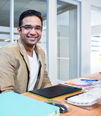 Happy partners looking at camera in the office