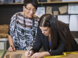 Two seamstresses making dressmakers pattern in workshop Two seamstresses making dressmakers pattern in workshop